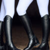 2 ladies standing together in tall boots