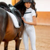 A lady standing with a horse