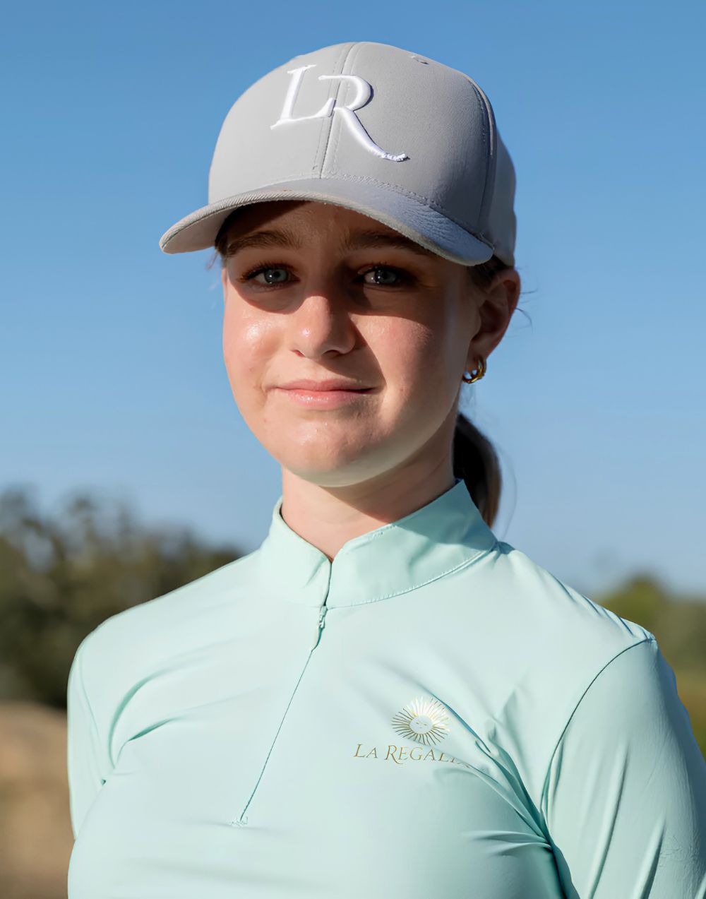 La Regalia LR Monogram Cap in grey and black with embroidered LR monogram, structured curved brim and adjustable strap, premium equestrian lifestyle cap