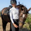 La Regalia Lucero Baselayer with perforated upper panels, ¾ zip neckline, built-in sun protection and signature Argentinian sun embroidery on the collar